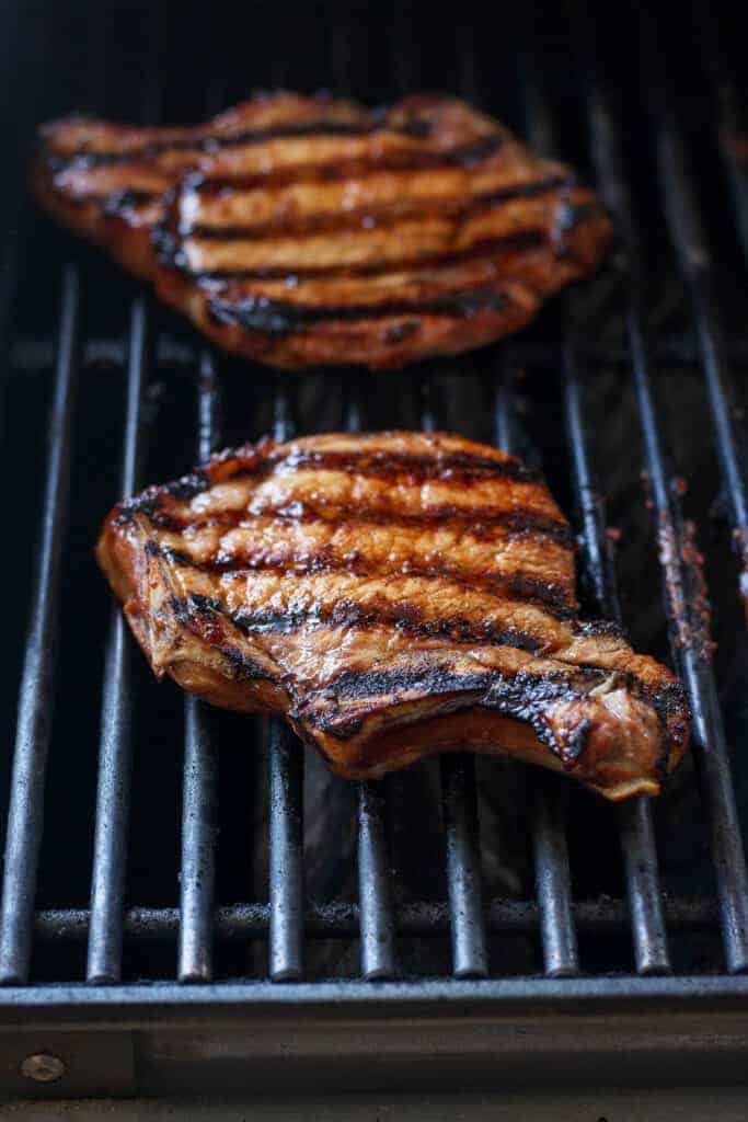 pork chops grilling on grill