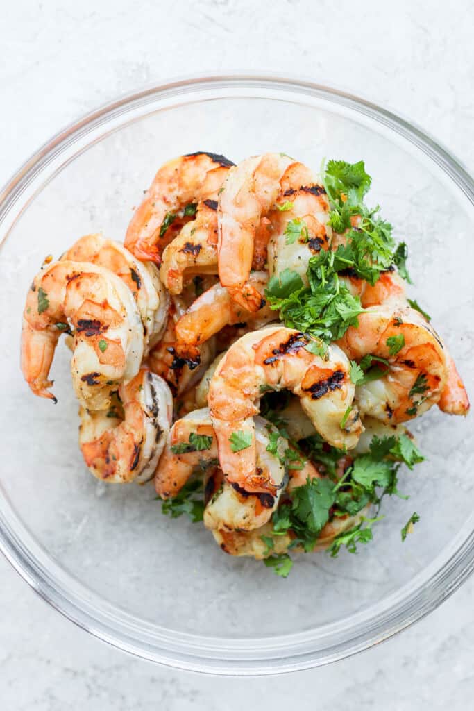 Grilled shrimp in a bowl with freshly chopped cilantro.