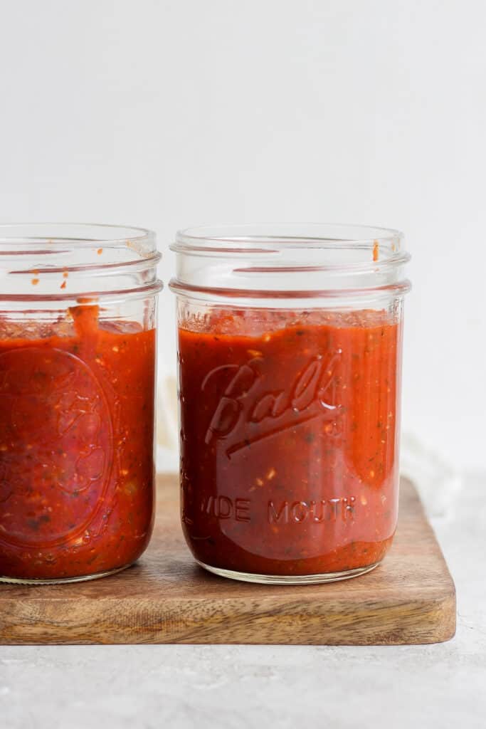 marinara sauce in 2 jars on cutting board