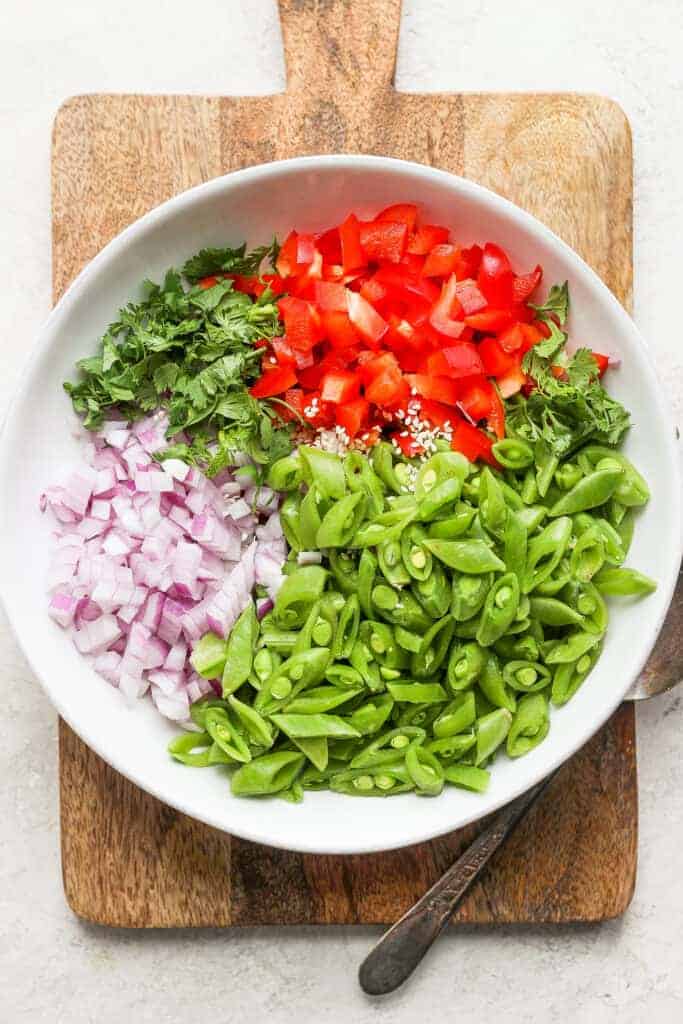 Ginger pea salad ingredients in a bowl. 