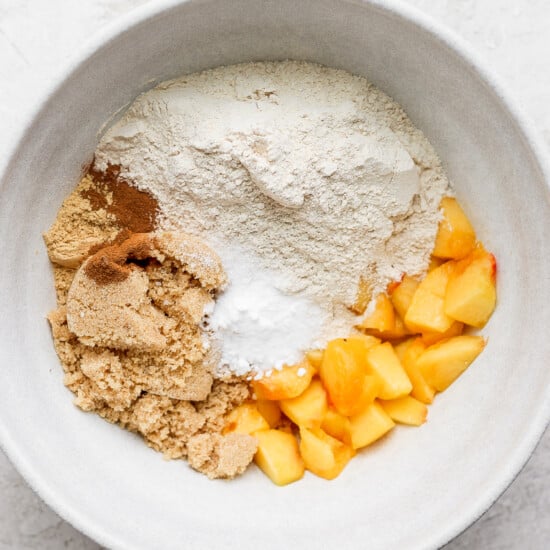 Peach crumble ingredients in a white bowl, perfect for peach muffins.