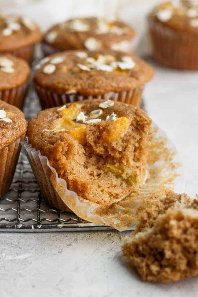 peach muffin with a bite taken out of it