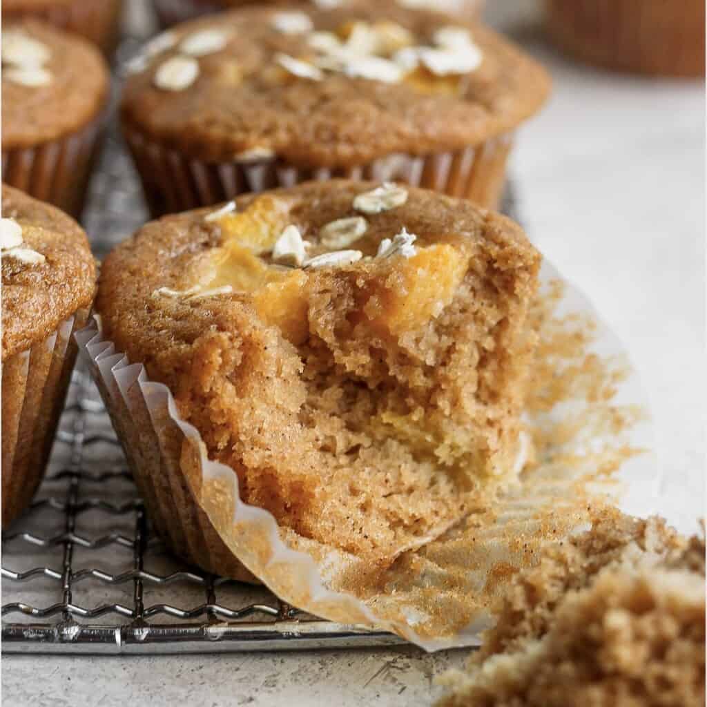 peach muffin with a bite taken out of it