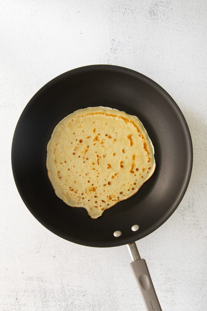 A crepe in a nonstick pan. 
