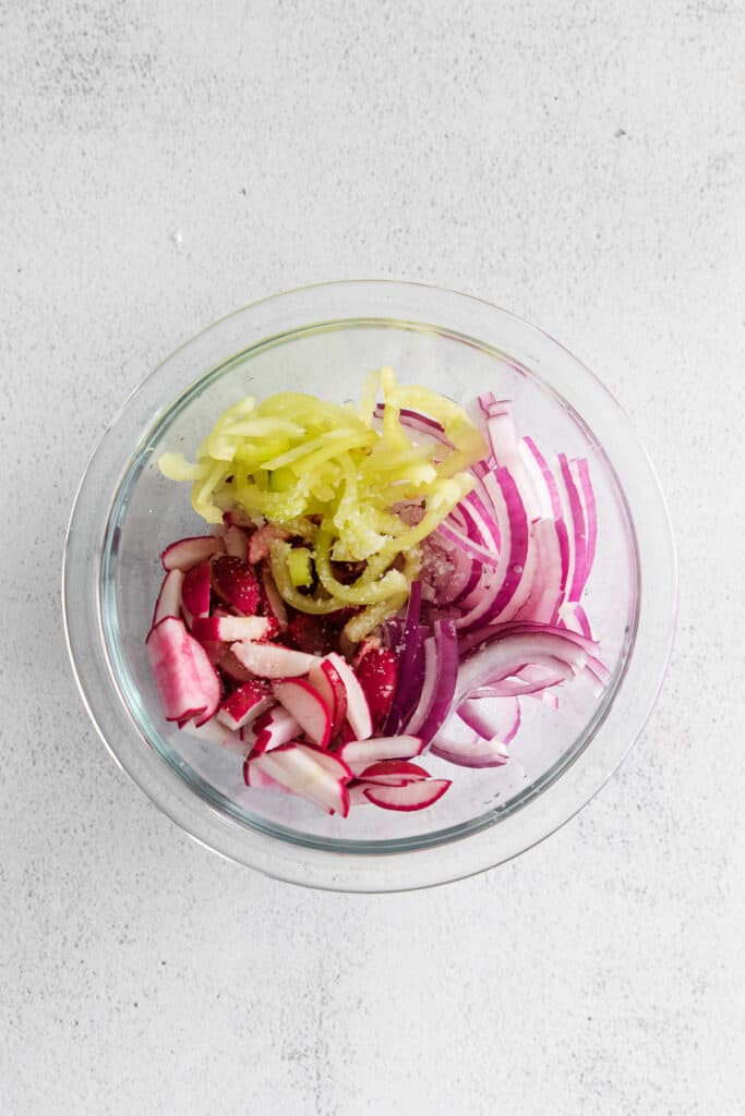 A radish slaw with banana peppers, red onion, and radishes. 