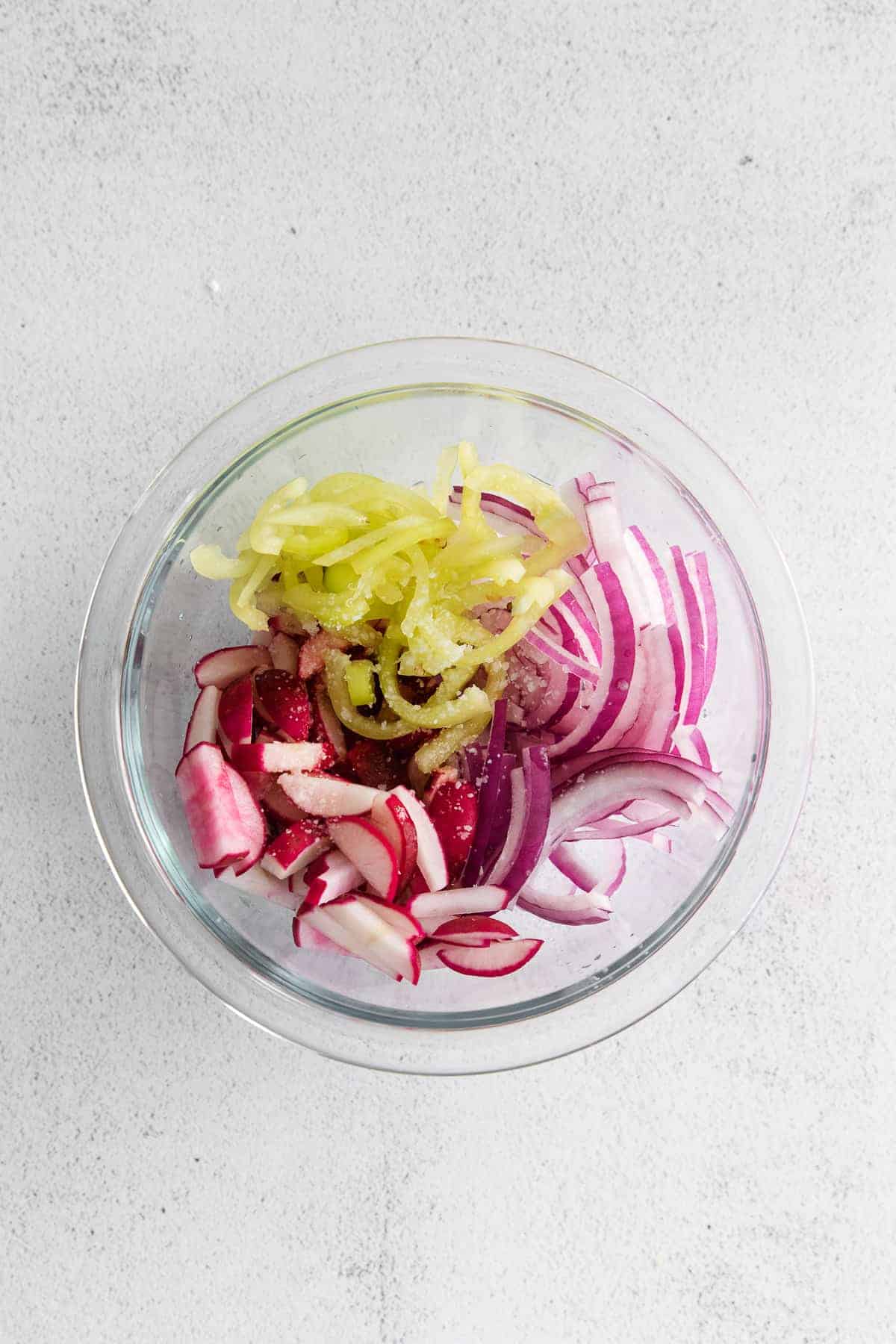 A radish slaw with banana peppers, red onion, and radishes. 