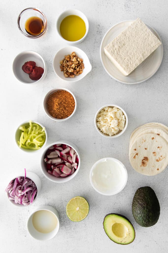 All the ingredients for tofu tacos in small dishes. 