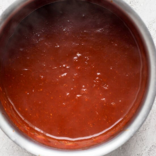 sauce in a pan on a white surface.