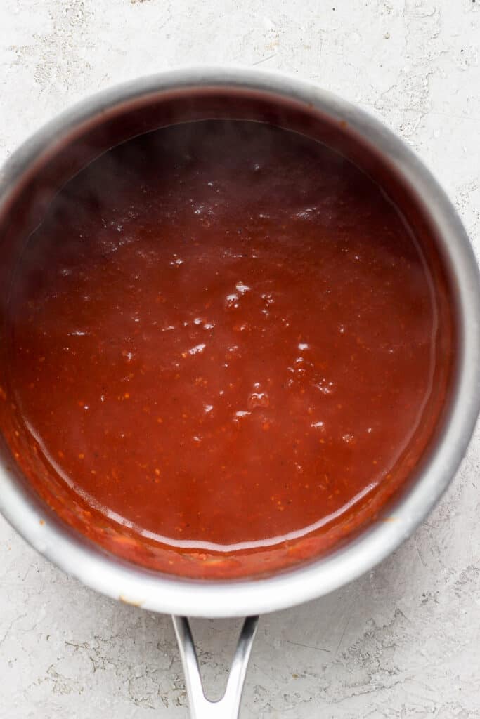 homemade BBQ sauce ingredients simmering in a sauce pan.
