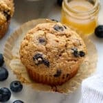 A close up of a healthy blueberry muffin on a plate.