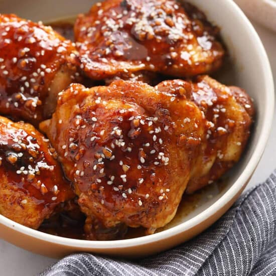 Honey garlic sesame chicken in a bowl.