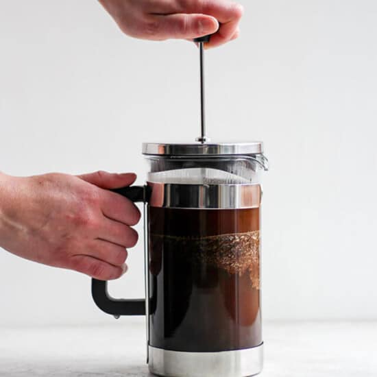 A person pouring coffee into a french press.