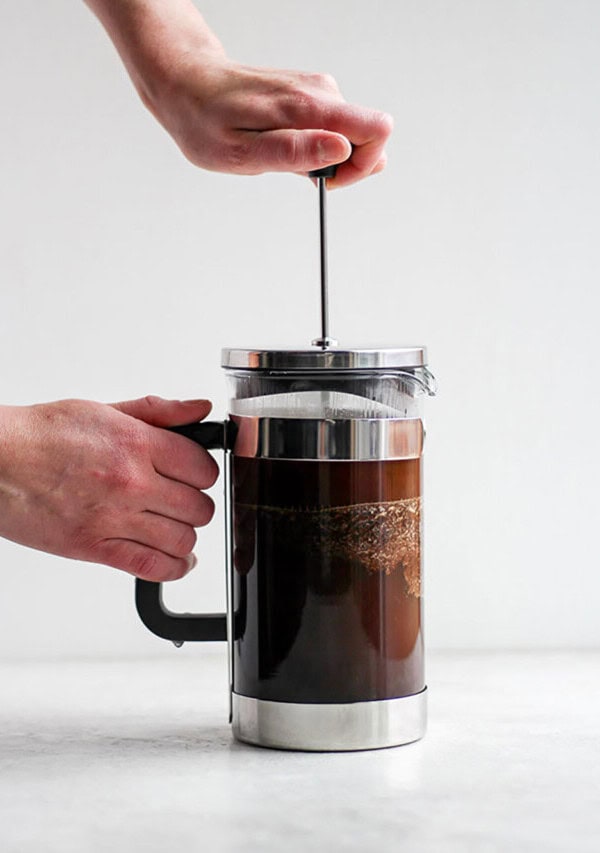 A person pouring coffee into a french press.