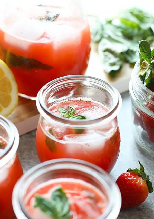 Strawberry lemonade in jars with mint leaves.