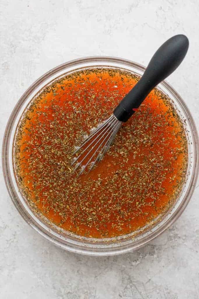 Broth, spices, and tomato paste in a bowl. 