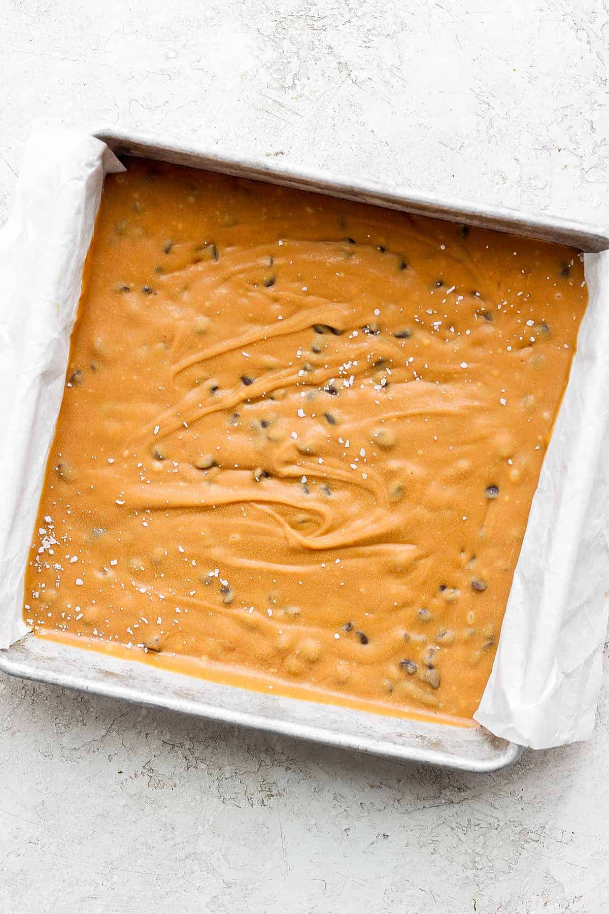 cookie dough freezer fudge in a cake pan after being frozen