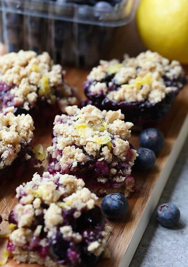 blueberry lemon crumb bars on a cutting board.