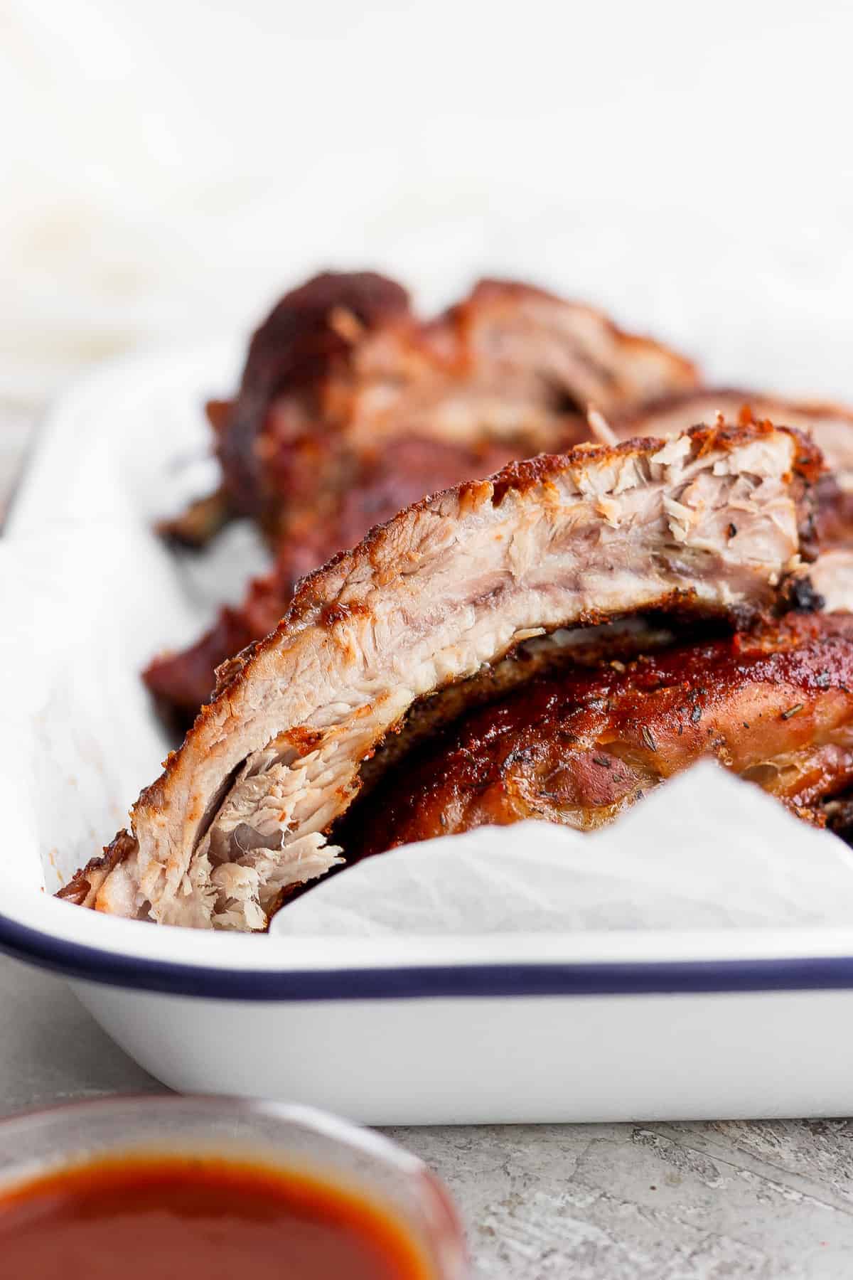 Finished baked ribs in a baking pan. 