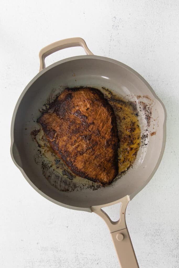 flank steak seared in a pan