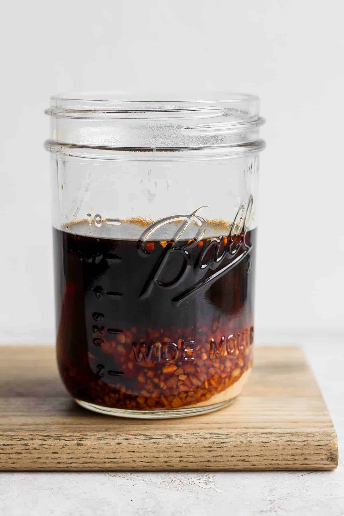 stir fry sauce in a mason jar before being shaken to be mixed together