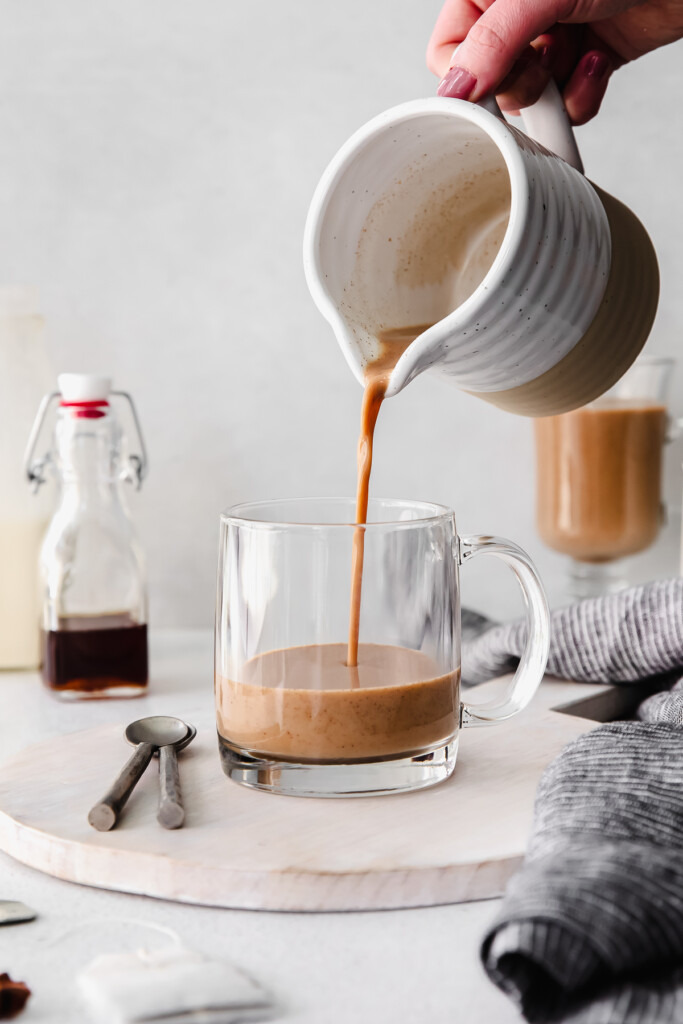 pouring chai tea into mug