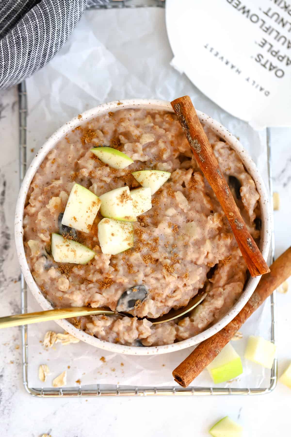 finished oat bowl topped with sliced apples and cinnamon