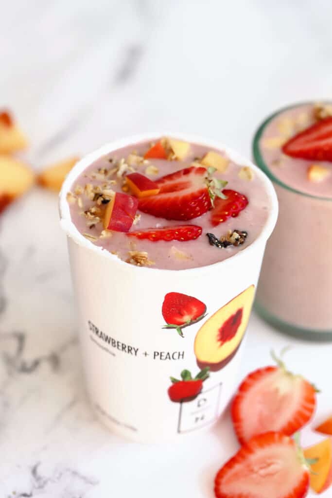 daily harvest smoothie in a cup topped with fresh berries