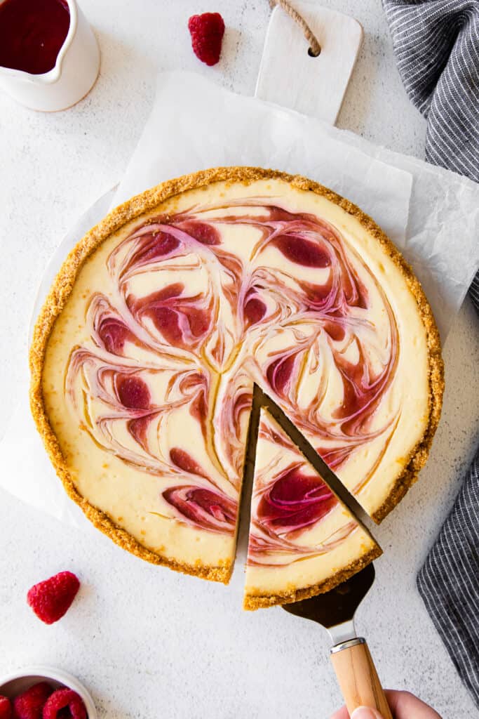 greek yogurt cheesecake with a raspberry swirl