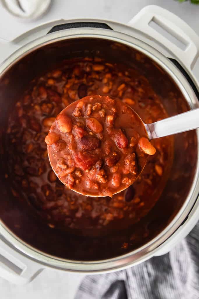 instant pot chili filling a ladle.