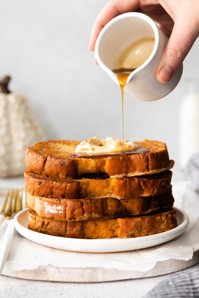 Pouring maple syrup over pumpkin french toast. 