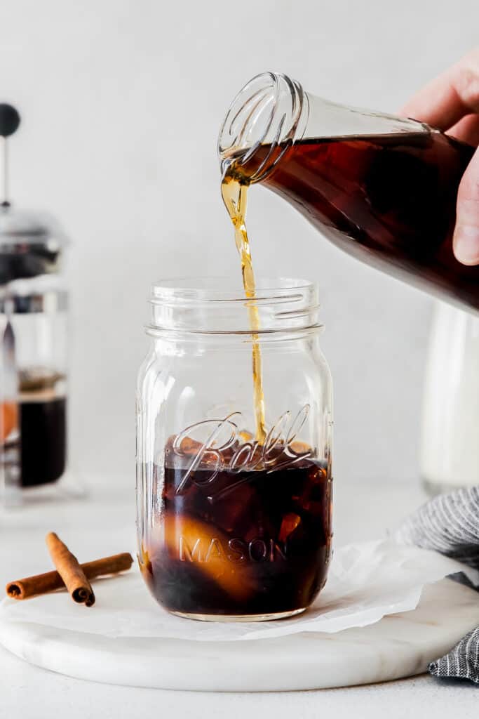 pouring espresso into glass