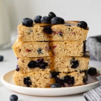 a stack of blueberry pancakes on a plate.