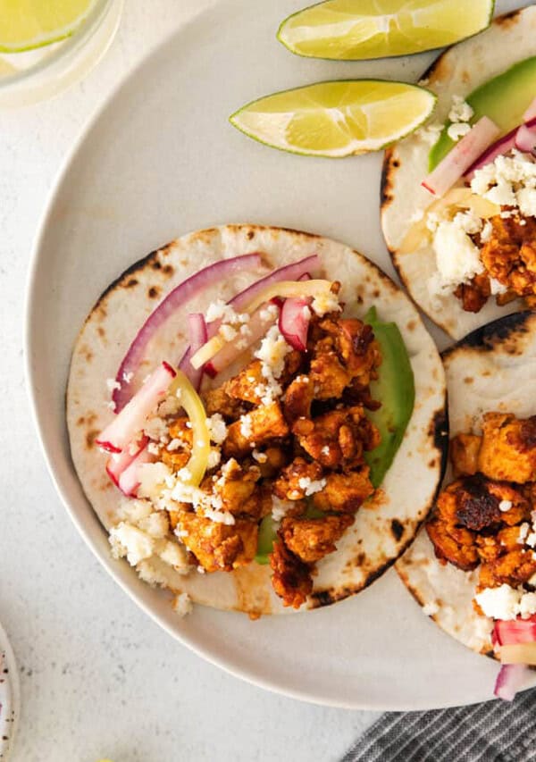 tofu tacos topped with slaw on plate