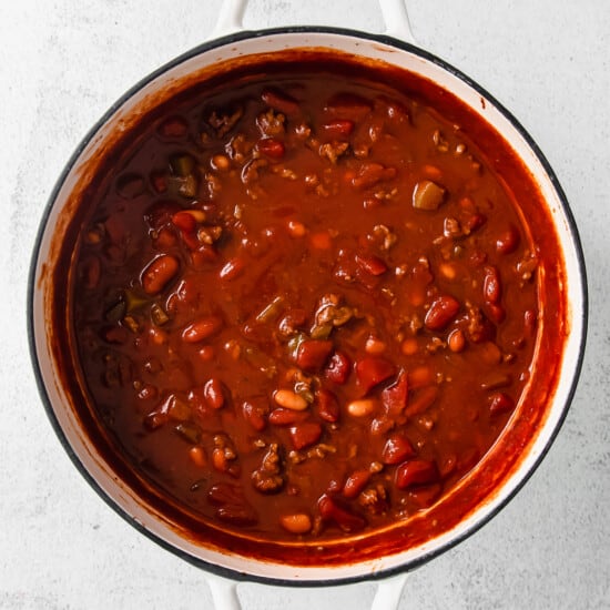 chili in a white pot on a white background.