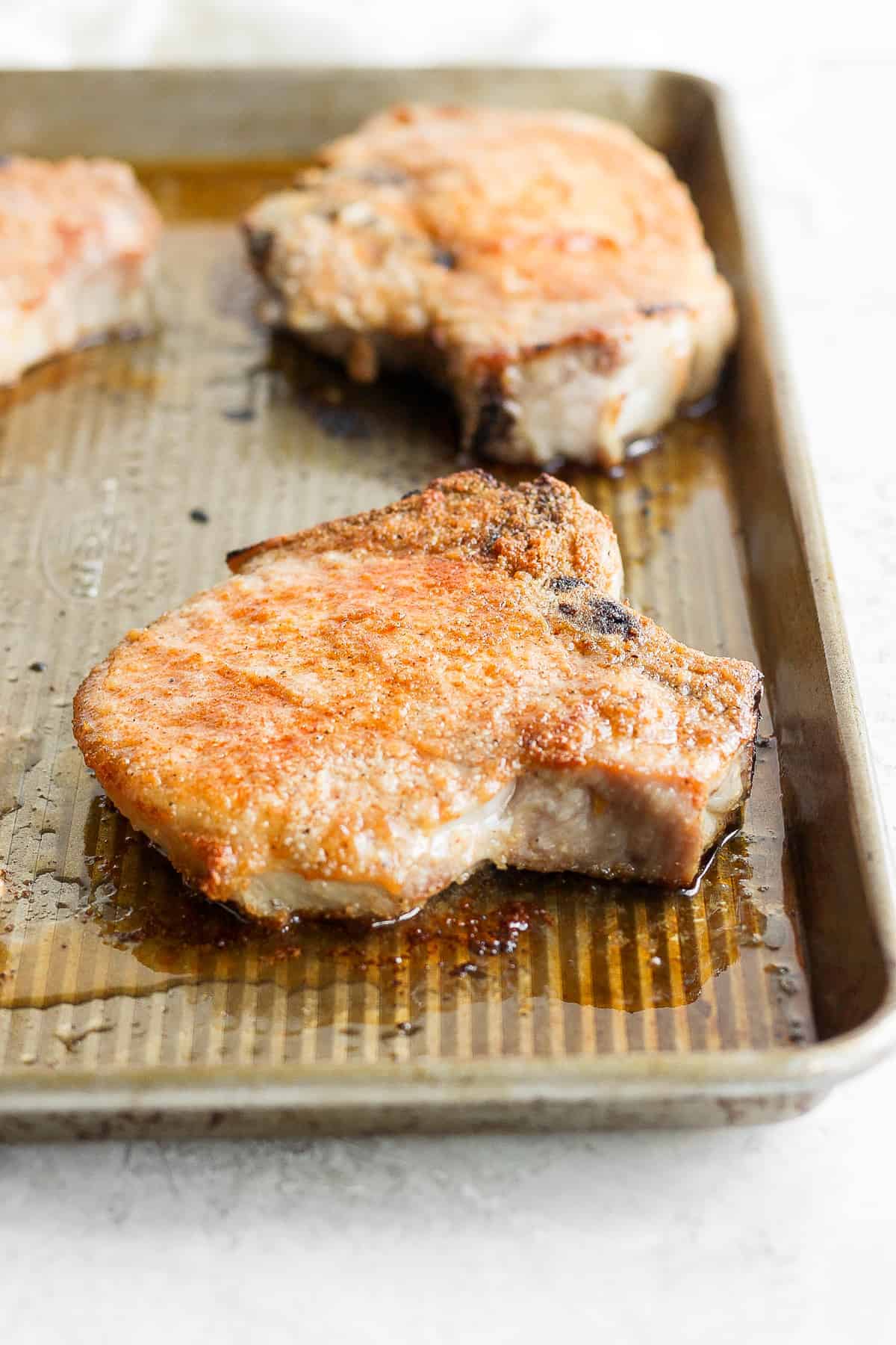 juicy oven baked pork chop on baking sheet