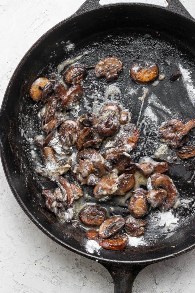 sauteed mushrooms in a cast iron skillet for ground beef stroganoff 