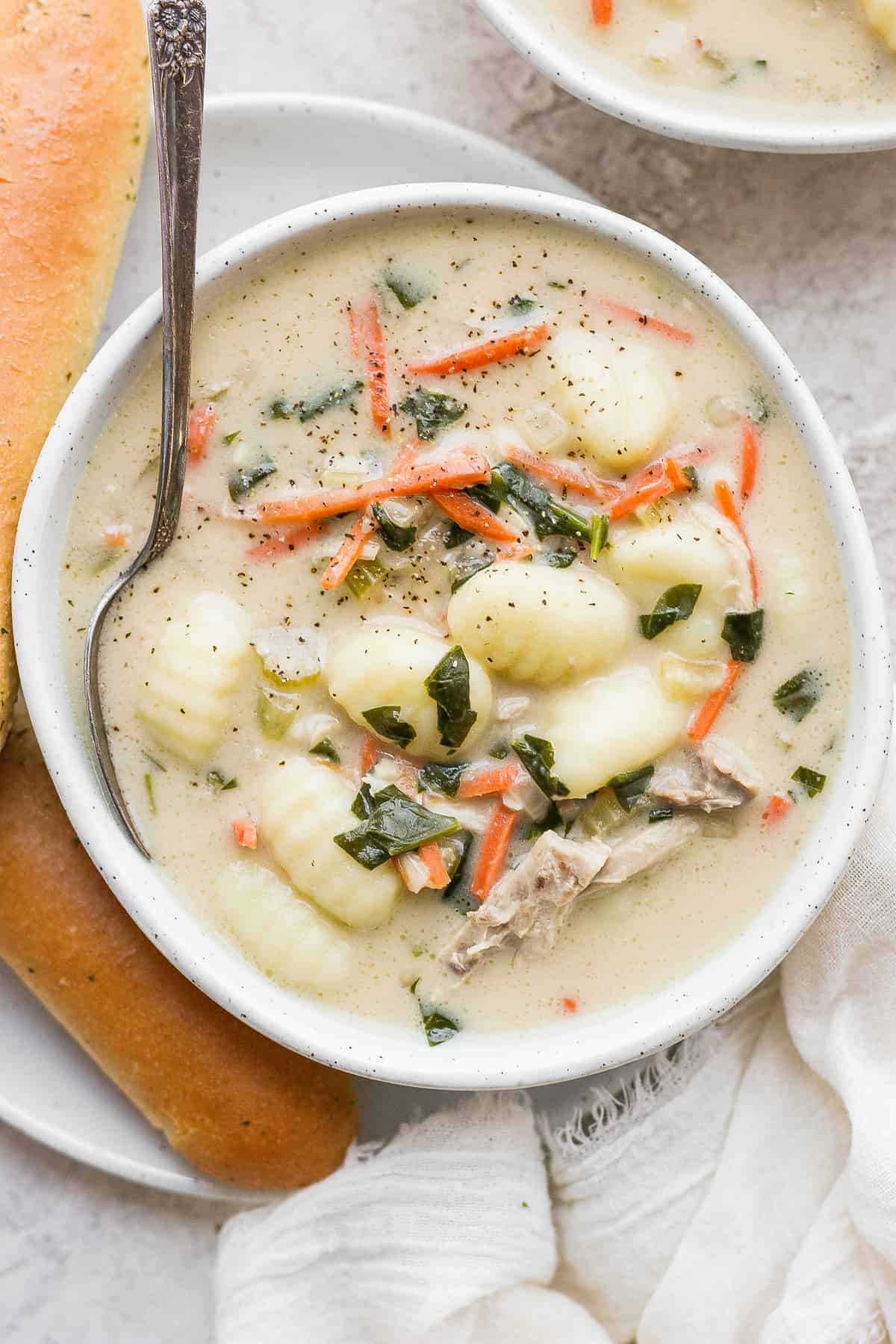 olive garden chicken gnocchi soup in a bowl with a spoon