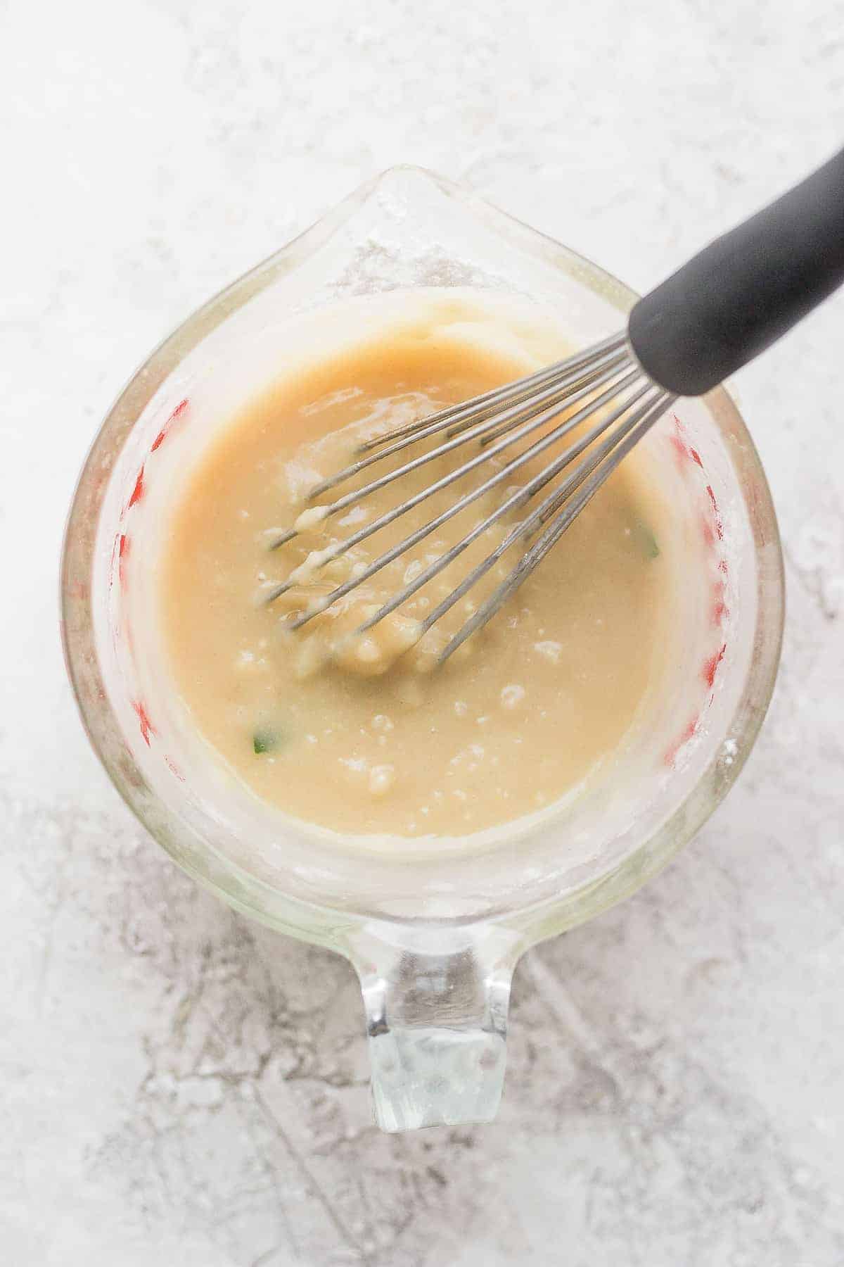 a slurry in a bowl being whisked together