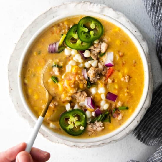 corn chowder in bowl with spoon