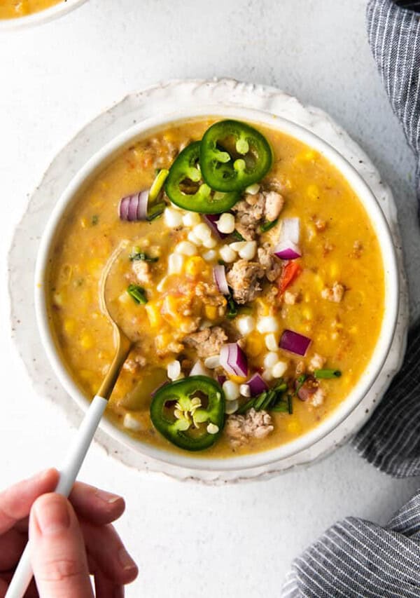 corn chowder in bowl with spoon