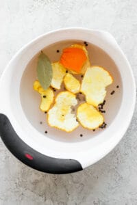 a bowl filled with orange slices and spices.