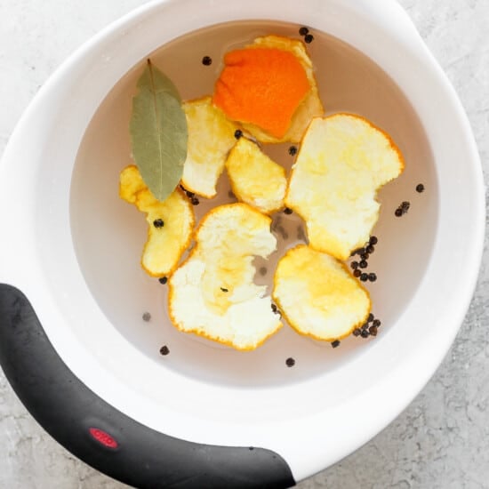 a bowl filled with orange slices and spices.