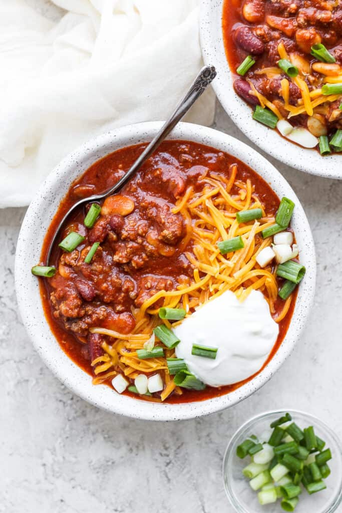 Slow cooker chili in a bowl with a spoon.