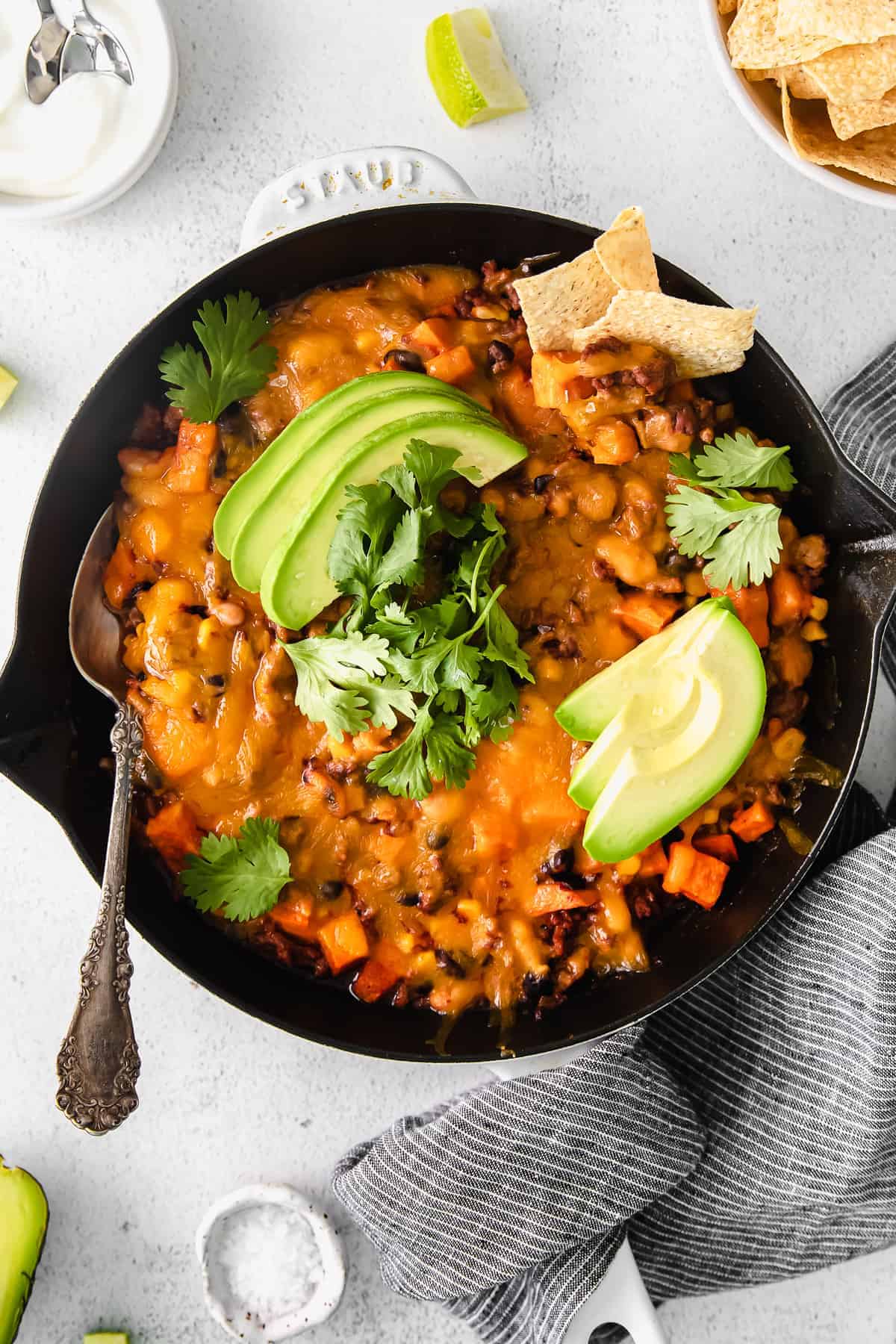 turkey sweet potato enchilada skillet topped with fresh avocado and cilantro