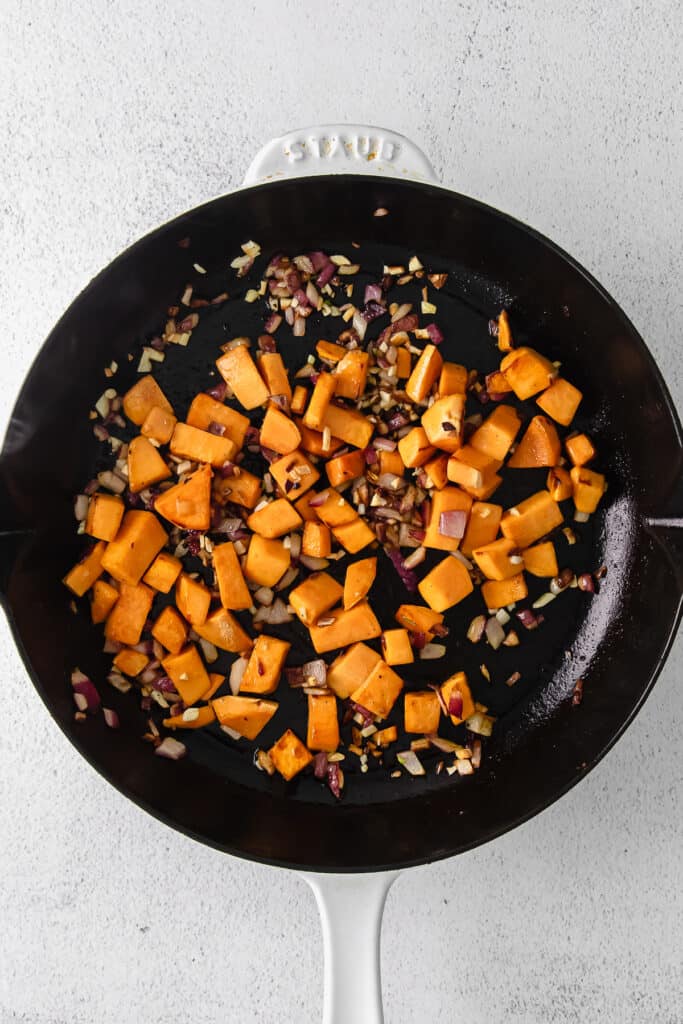 diced sweet potatoes in a cast iron skillet