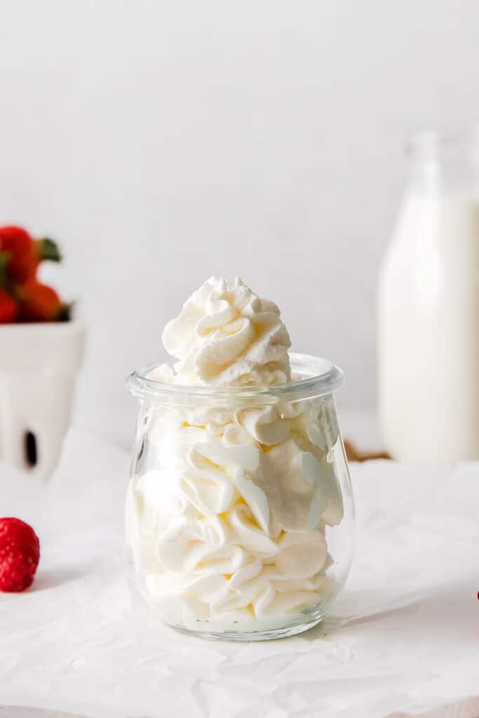 Homemade whipped cream in a small jar. 