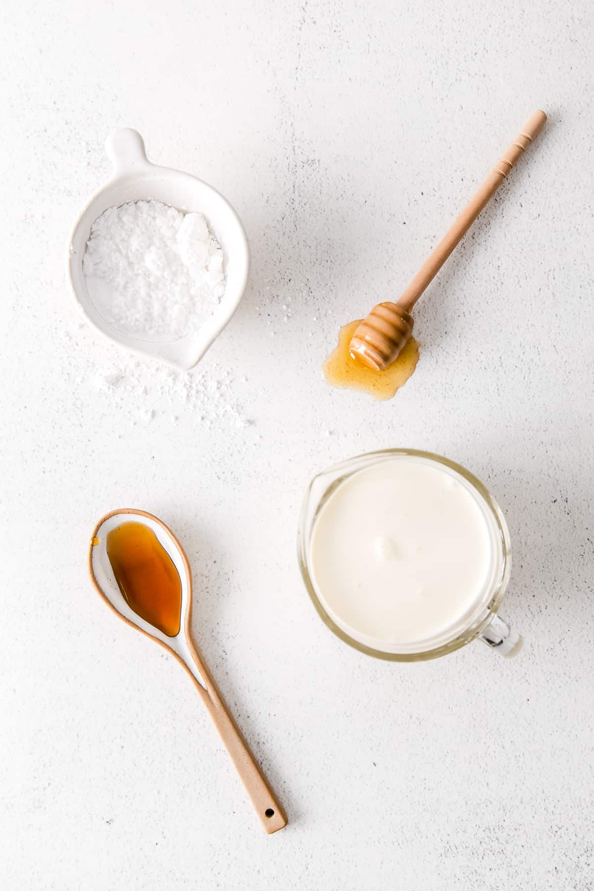 Ingredients for homemade whipped cream in small bowls. 