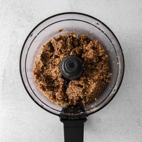 a food processor filled with a brown mixture.