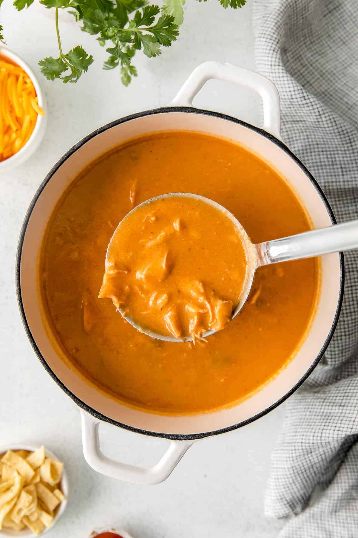 A ladle full of chicken enchilada soup. 