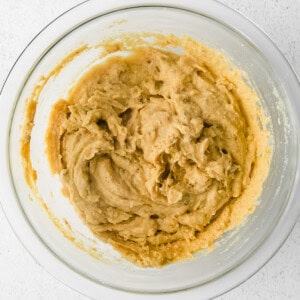 peanut butter in a bowl on a white background.